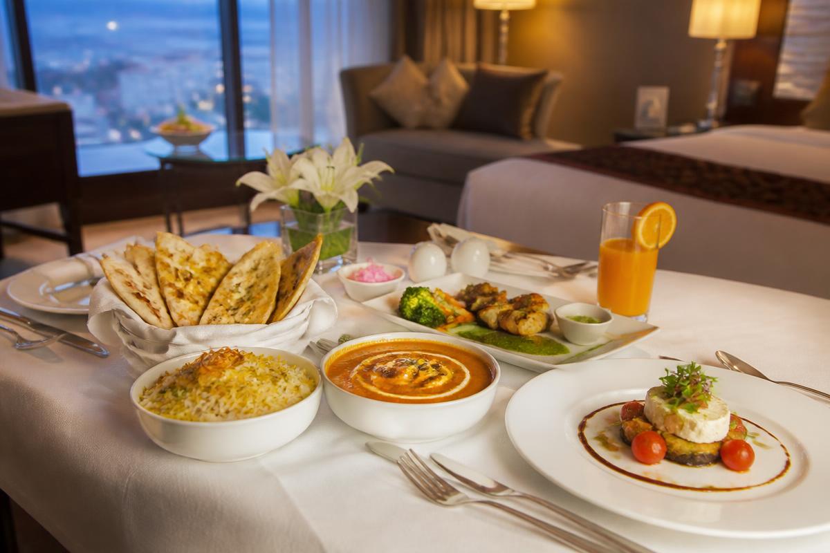 In-Room Dining — Full multi-cuisine menu, delivered hot to your door.